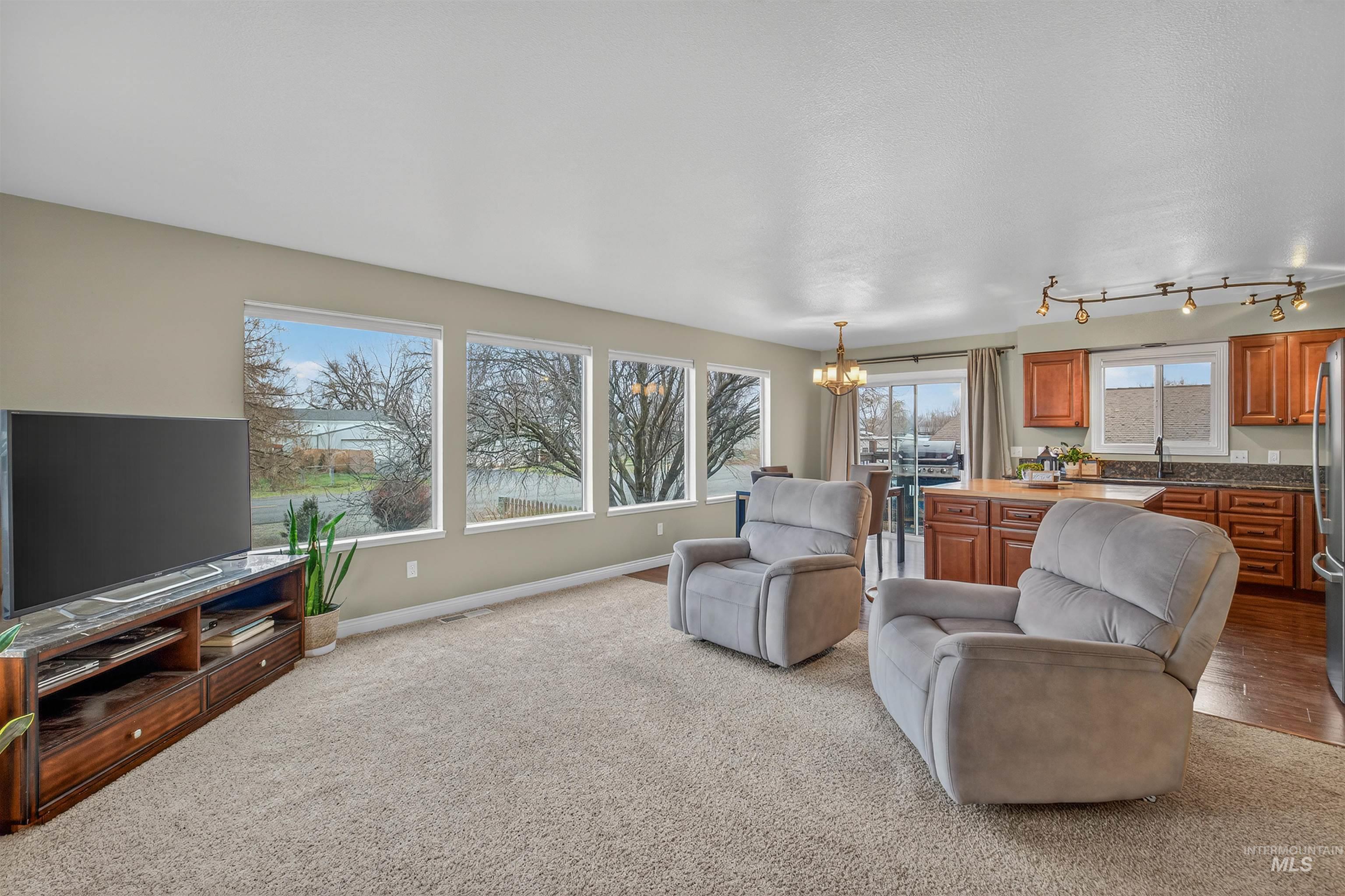 2814 22nd Street Clarkston, WA 99403 - Photo 7 of 33 Living area with a chandelier and light carpet
