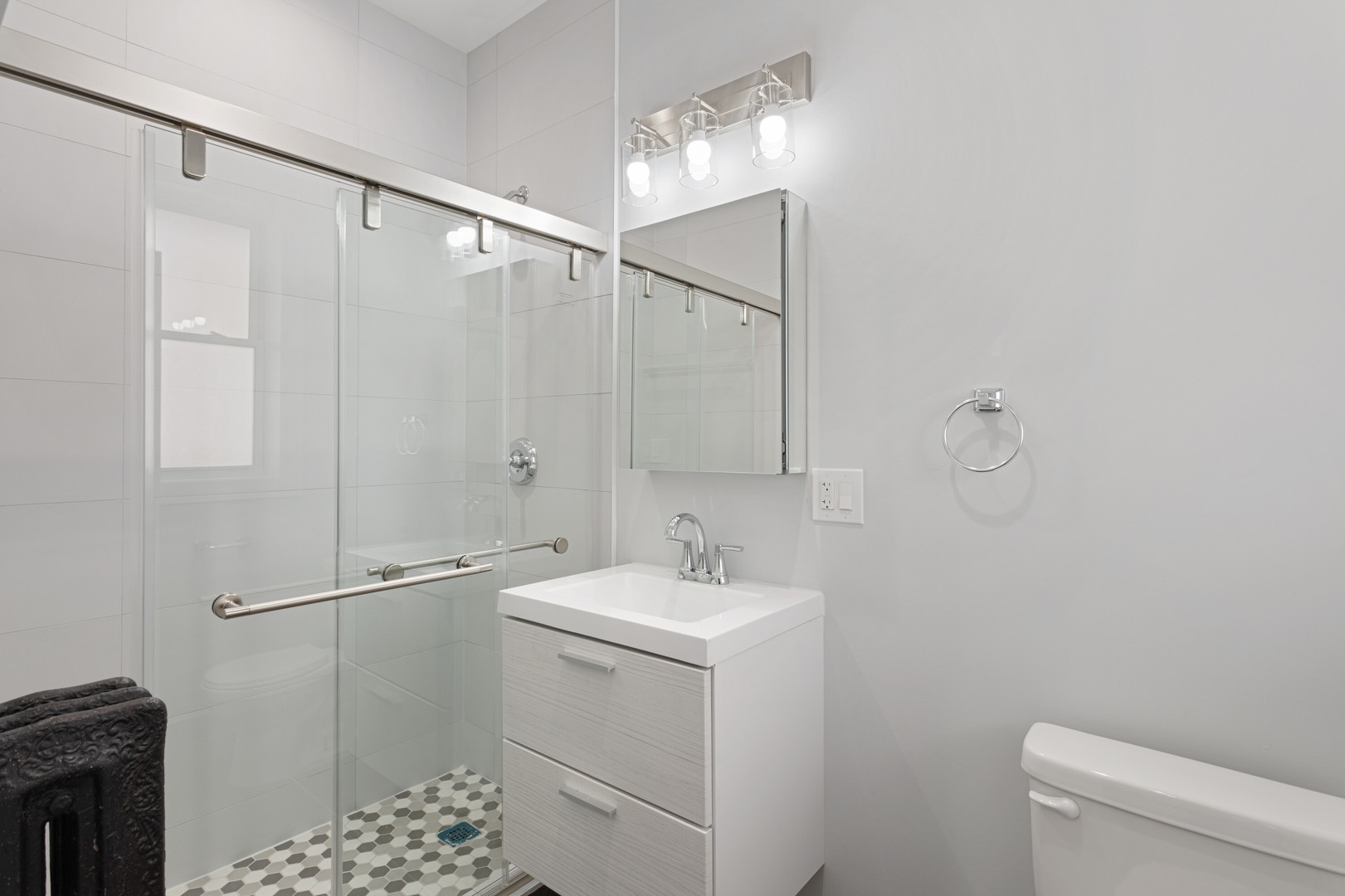 7425 North Clark Street, Unit 3 Chicago, IL 60626 - Photo 12 of 15 a bathroom with a sink a toilet and shower