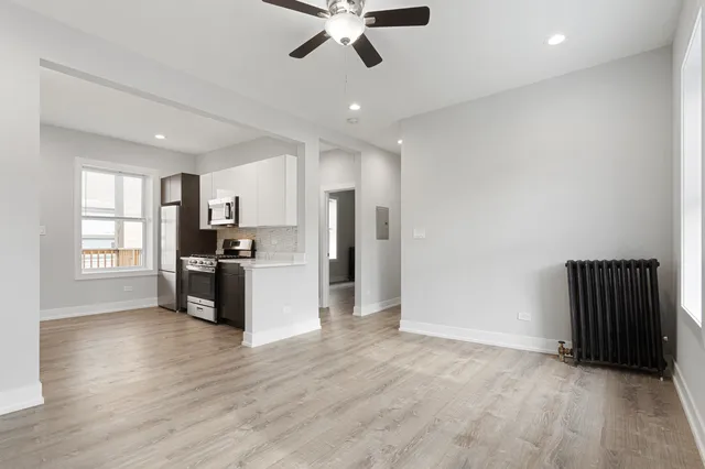 a view of kitchen with refrigerator and window