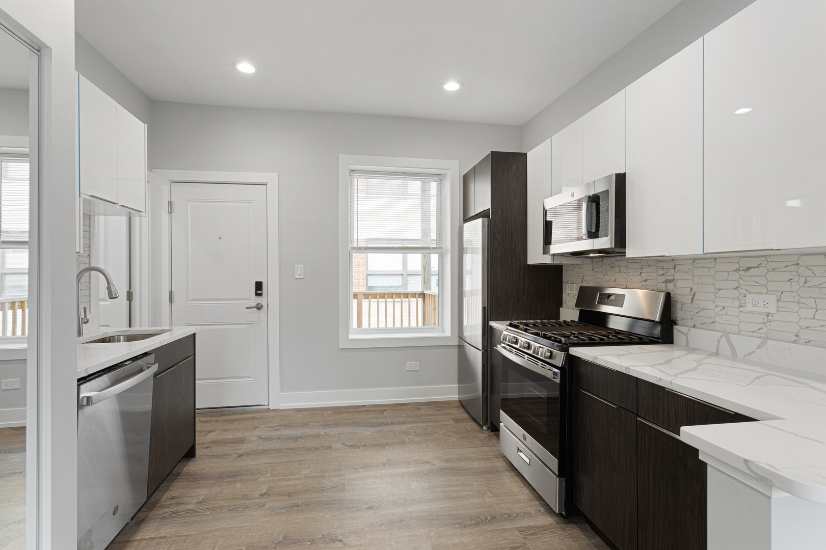 7425 North Clark Street, Unit 3 Chicago, IL 60626 - Photo 5 of 15 a kitchen with granite countertop a stove top oven sink and cabinets