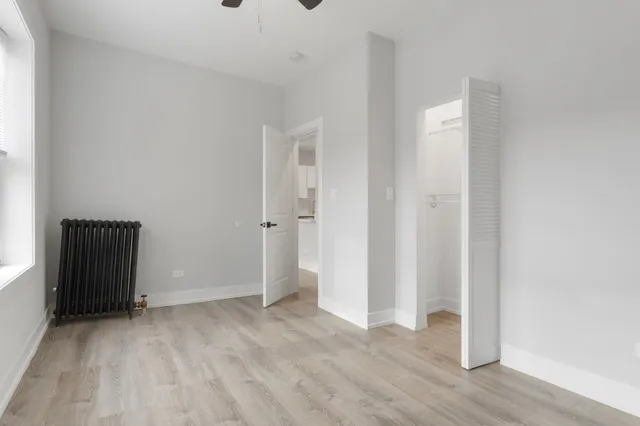 a view of an empty room and wooden floor