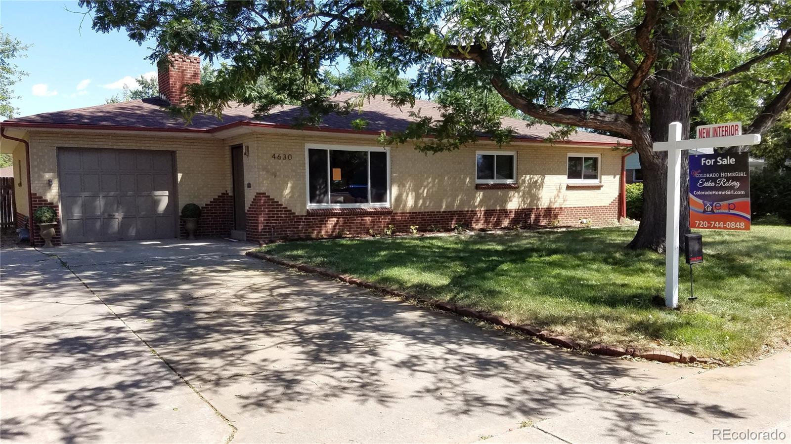 4630 Quay Street Wheat Ridge, CO 80033 - Photo 1 of 36 a front view of a house with garden