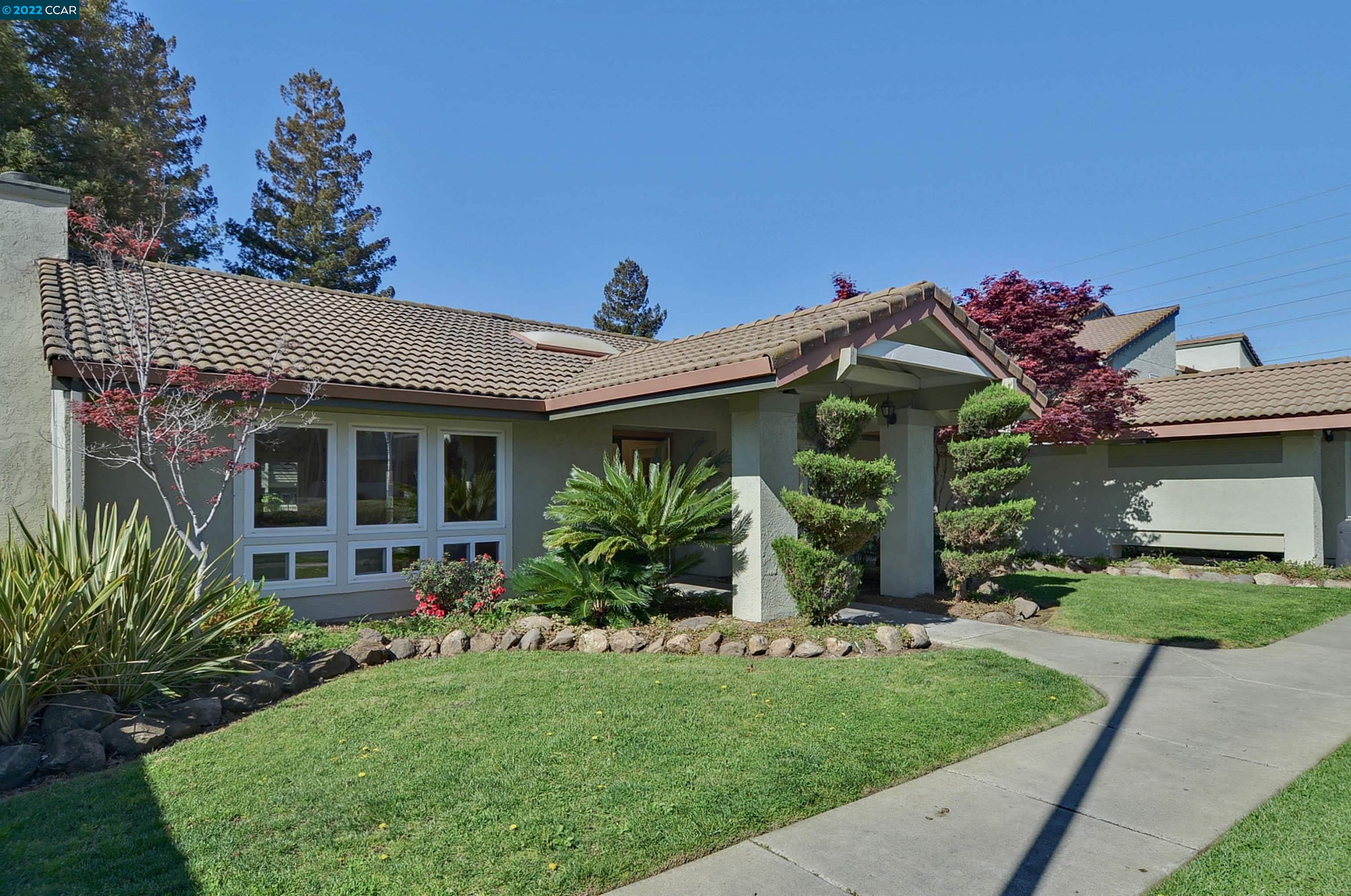 1505 Kirker Pass Road, Unit 138 Concord, CA 94521 - Photo 1 of 1 a front view of a house with a garden