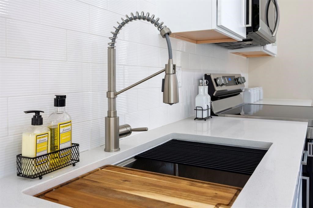 6832 Morrow Street, Unit A Houston, TX 77091 - Photo 11 of 16 a bedroom with a bed a mirror and lamp on dresser