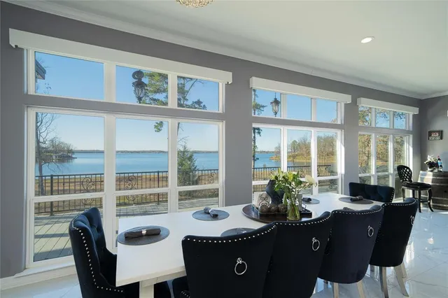 a view of a dining room with furniture large windows and wooden floor
