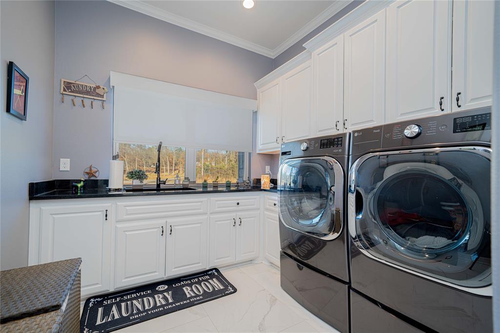 145 County Road Pittsburg, TX 75686 - Photo 15 of 39 a utility room with sink dryer and washer