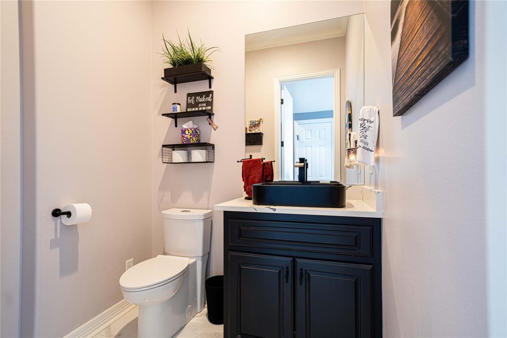 145 County Road Pittsburg, TX 75686 - Photo 16 of 39 a bathroom with a sink a toilet and a mirror