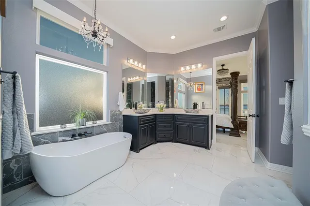 a large spacious bathroom with a large tub shower and sink