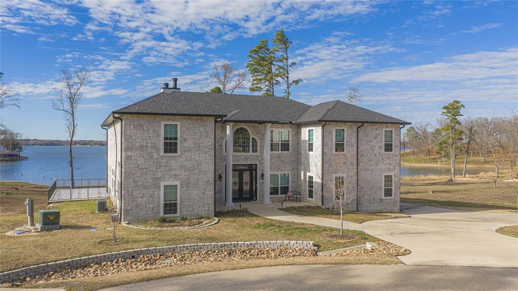145 County Road Pittsburg, TX 75686 - Photo 2 of 39 a view of a house with a patio