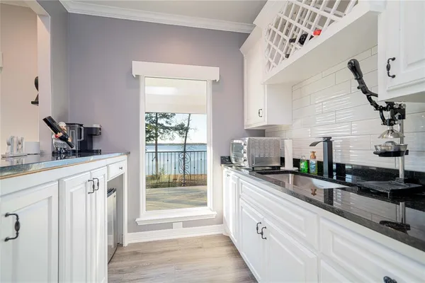 a kitchen with granite countertop a sink and a stove