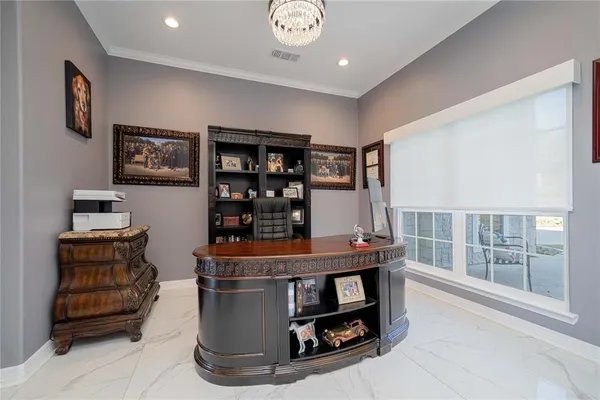 a living room with furniture and a book shelf