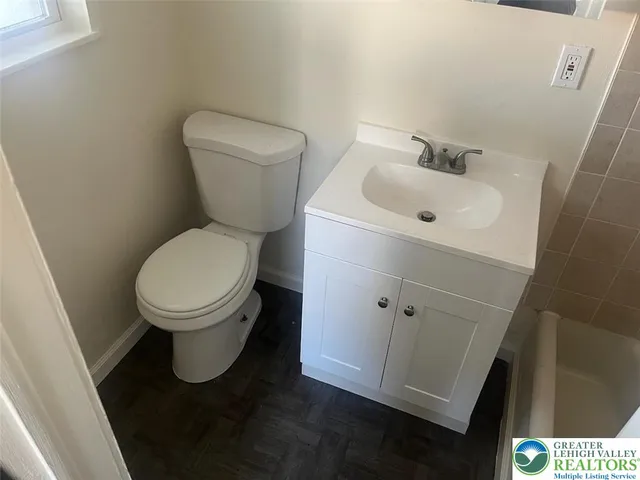 a white toilet sitting next to a bathroom sink