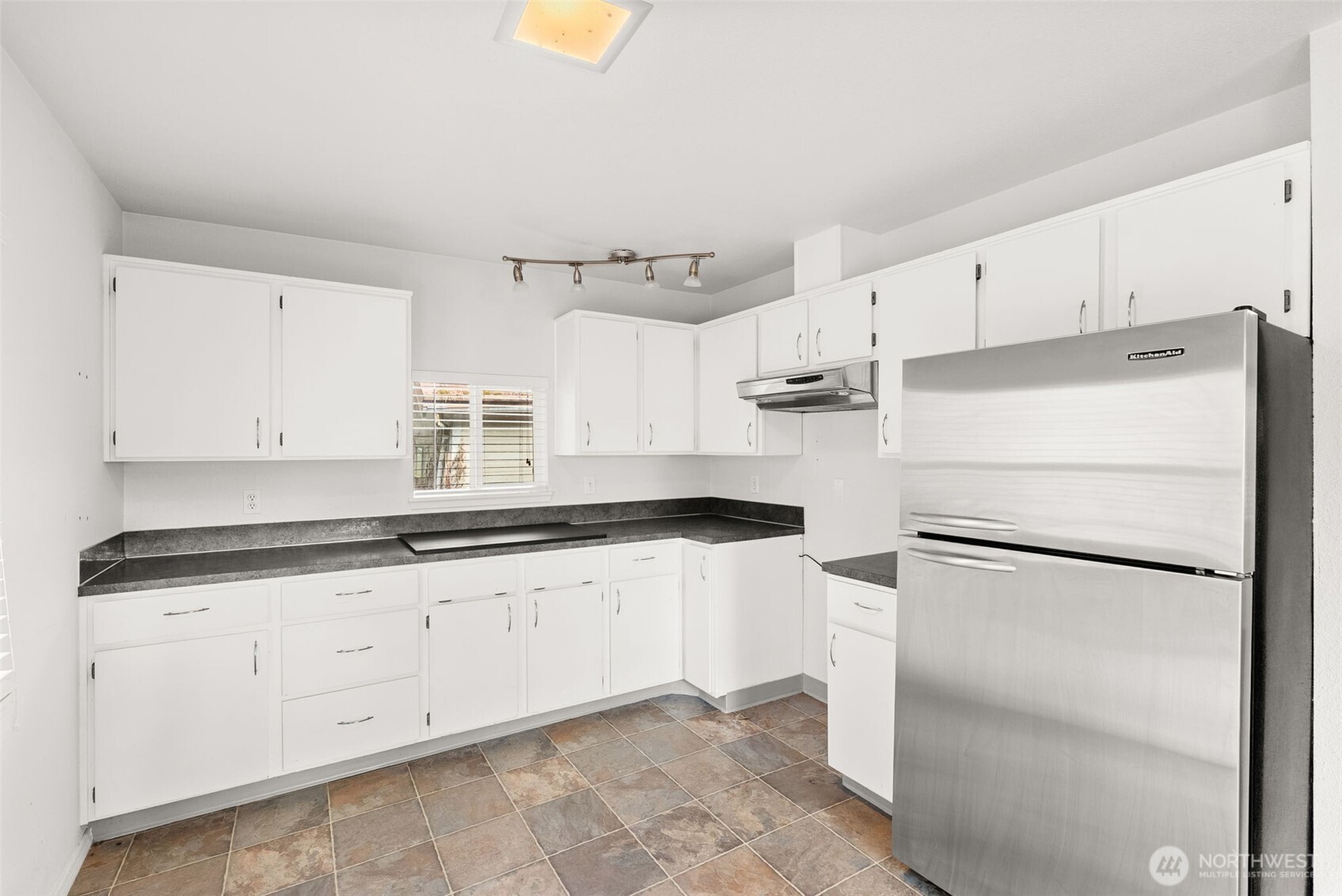 418 Southwest Canyon Loop Winlock, WA 98596 - Photo 12 of 35 a kitchen with granite countertop cabinets appliances and a counter space