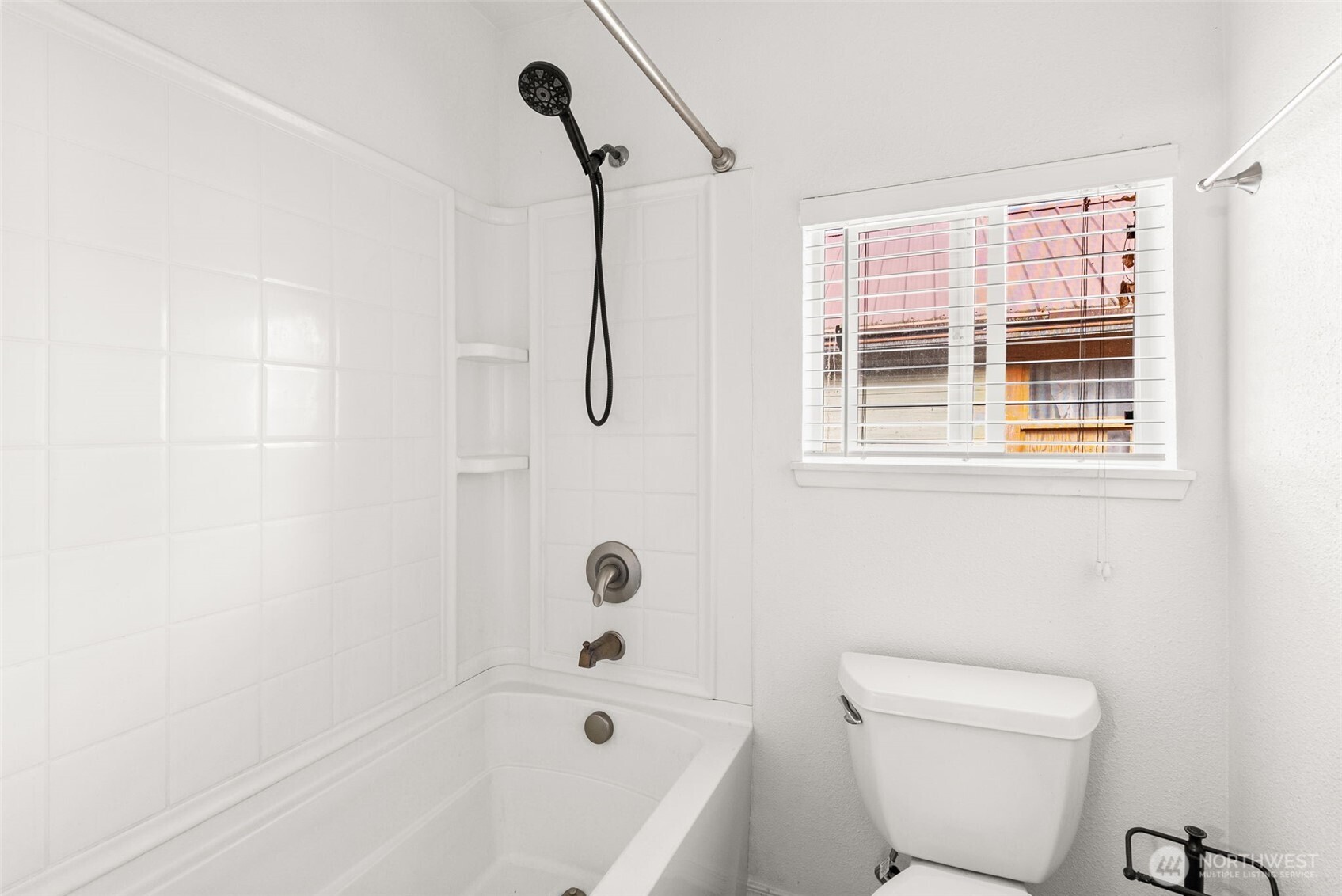 418 Southwest Canyon Loop Winlock, WA 98596 - Photo 16 of 35 a bathroom with a bathtub a window and a shower