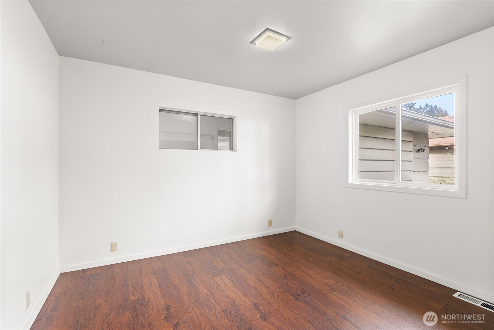 418 Southwest Canyon Loop Winlock, WA 98596 - Photo 17 of 35 an empty room with wooden floor and windows