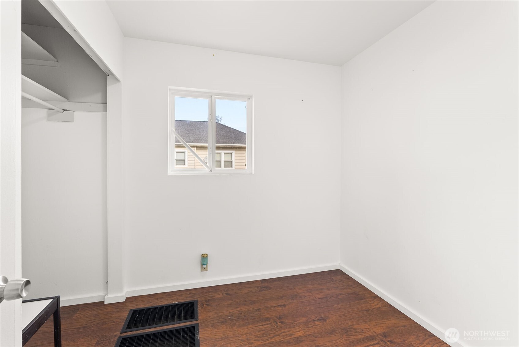418 Southwest Canyon Loop Winlock, WA 98596 - Photo 20 of 35 a view of an empty room with wooden floor and a window