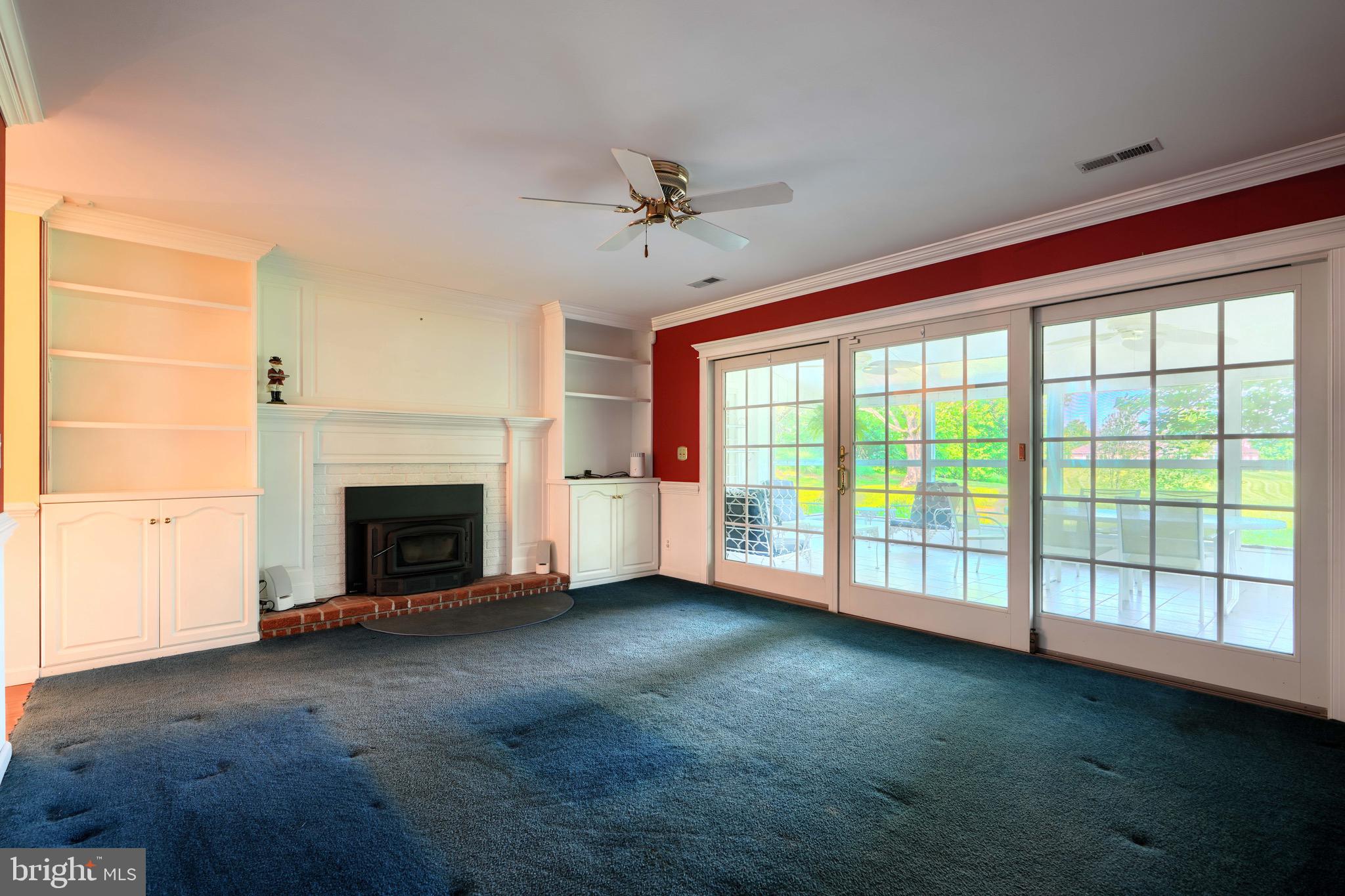 15009 La Vale Road Monkton, MD 21111 - Photo 25 of 45 family room with wood stove, sliders, and builtins