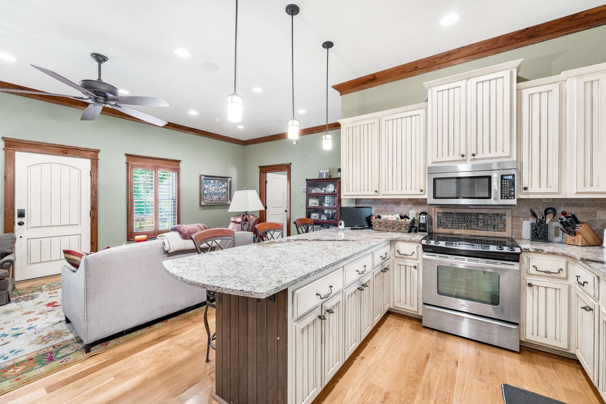 1257 Harris Hollow Road Charlotte, TN 37036 - Photo 13 of 53 a kitchen with stainless steel appliances granite countertop a sink a stove and a wooden floors