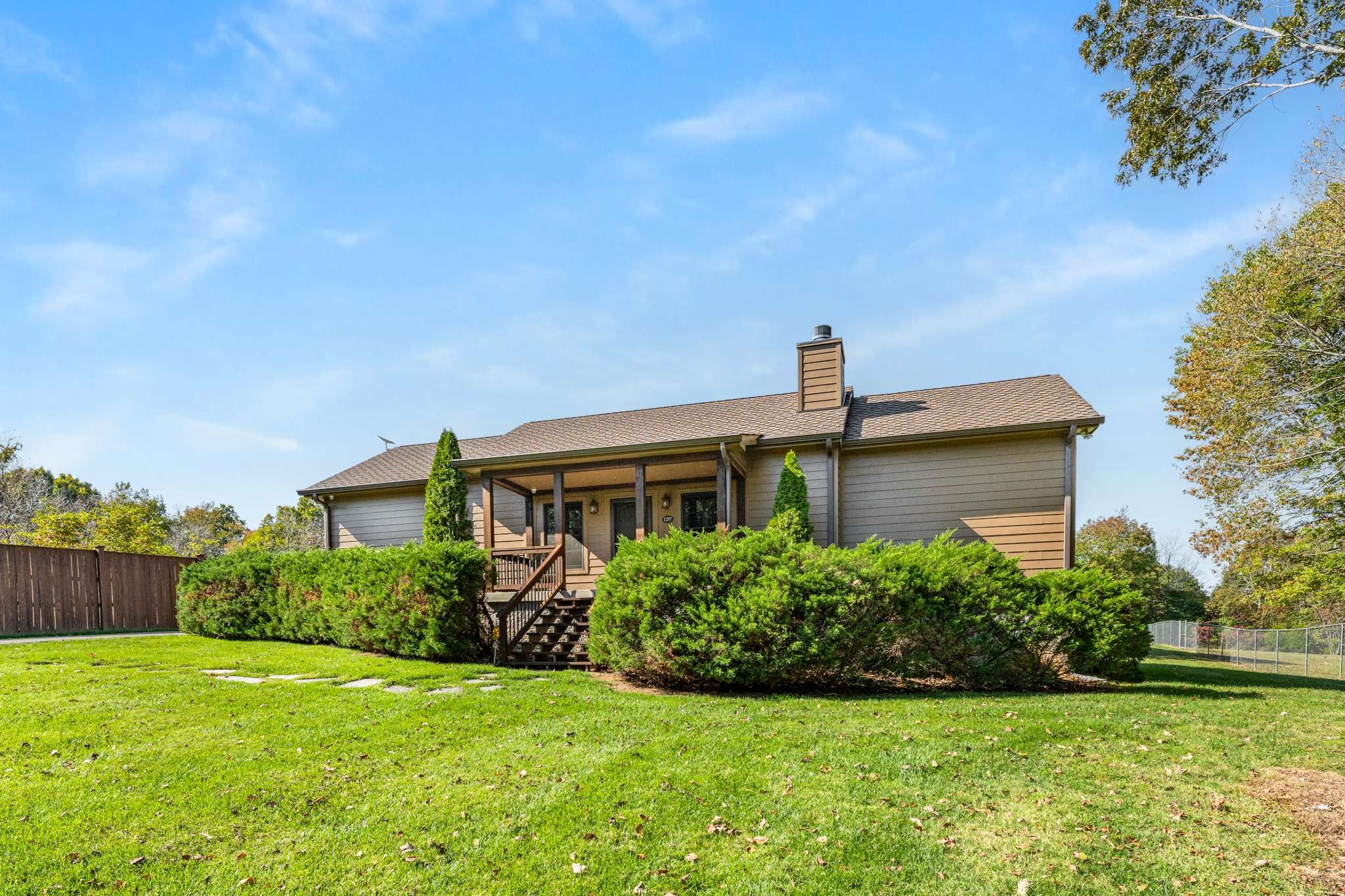 1257 Harris Hollow Road Charlotte, TN 37036 - Photo 3 of 53 a front view of a house with garden