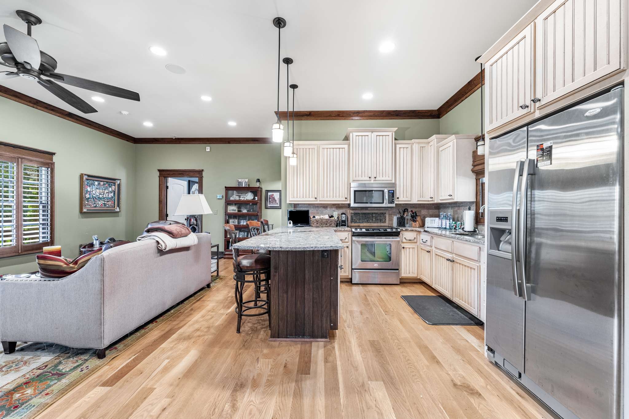 1257 Harris Hollow Road Charlotte, TN 37036 - Photo 7 of 53 a large kitchen with kitchen island a large counter space a sink stainless steel appliances and cabinets