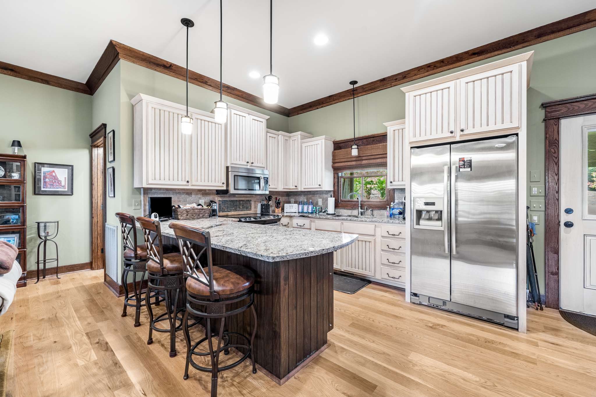 1257 Harris Hollow Road Charlotte, TN 37036 - Photo 8 of 53 a kitchen with stainless steel appliances granite countertop a table chairs and a refrigerator