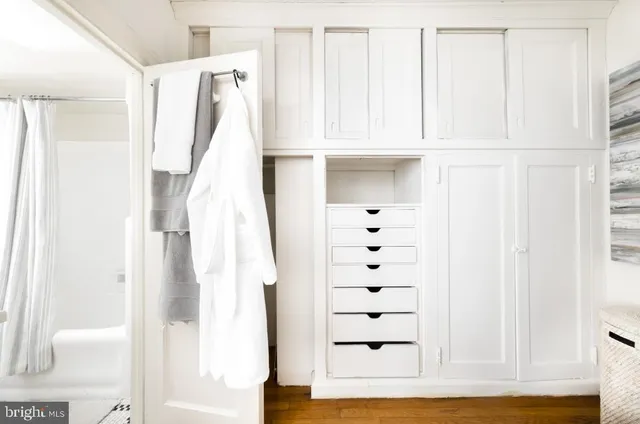 a view of walk in closet with white walls
