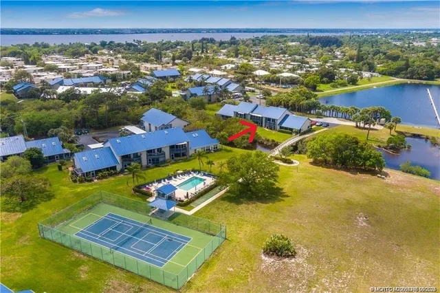 an aerial view of residential houses with outdoor space and swimming pool