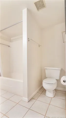 a view of a room that has a window and a chair