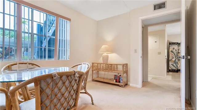 a view of a chairs and table in patio with a yard