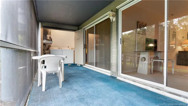 a view of a hallway with furniture