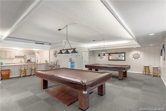a kitchen with granite countertop a sink stove and refrigerator