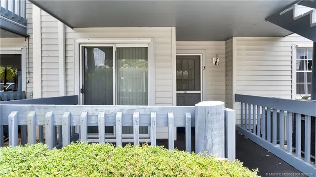 a view of a house with wooden fence
