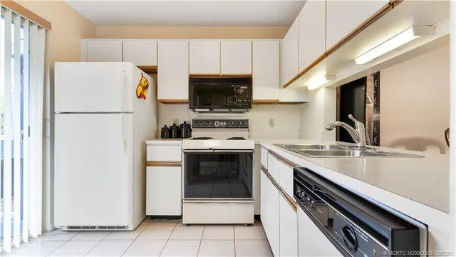 a kitchen with a refrigerator stove and microwave
