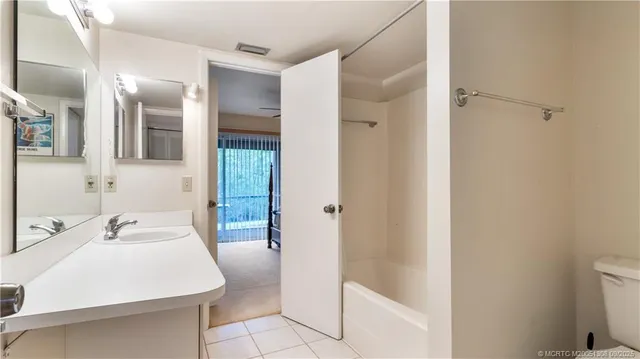 a bathroom with a sink a mirror and a shower