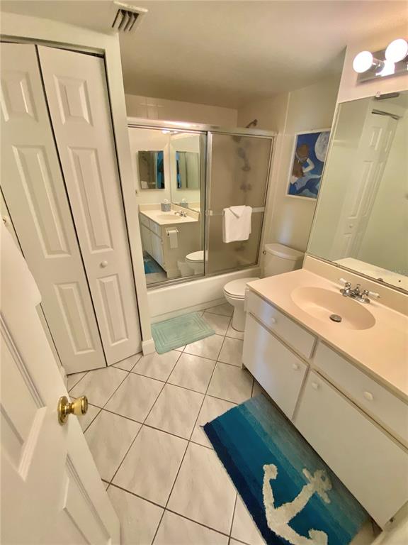 6035 Sea Ranch Drive, Unit 901 Hudson, FL 34667 - Photo 15 of 72 a bathroom with a sink a toilet and a mirror