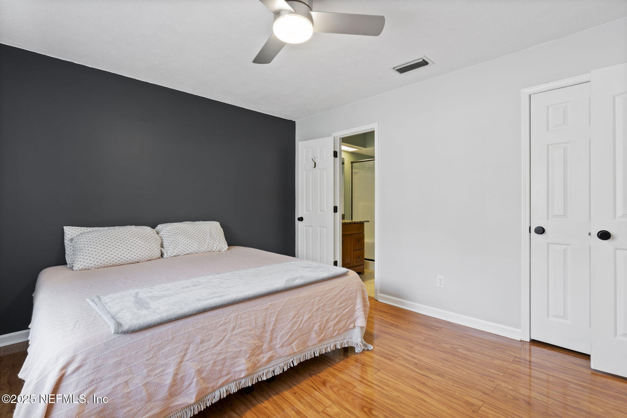 26 Bullrush Court Middleburg, FL 32068 - Photo 19 of 43 a bedroom with a bed and wooden floor