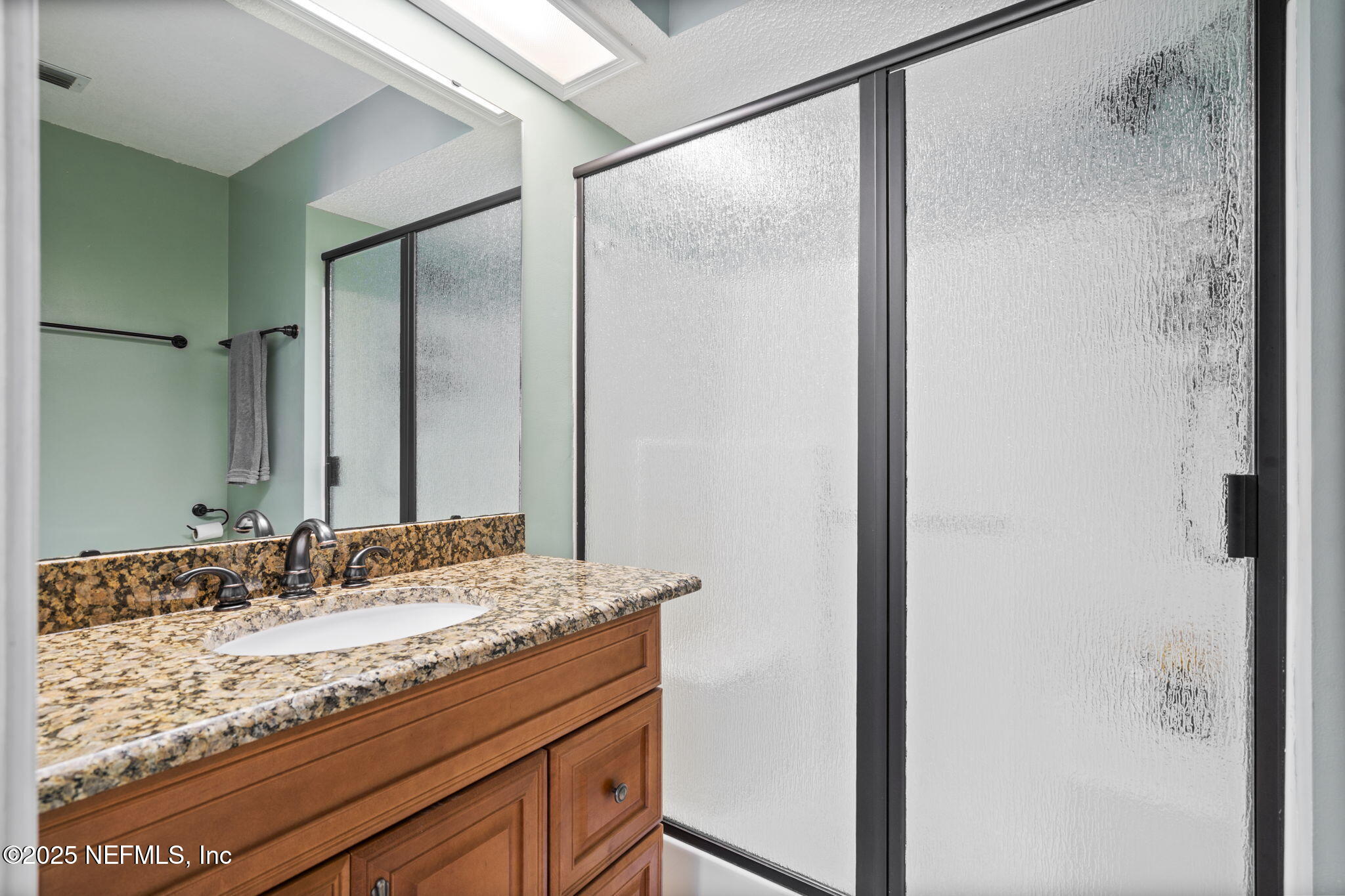 26 Bullrush Court Middleburg, FL 32068 - Photo 21 of 43 a bathroom with a granite countertop sink and a mirror