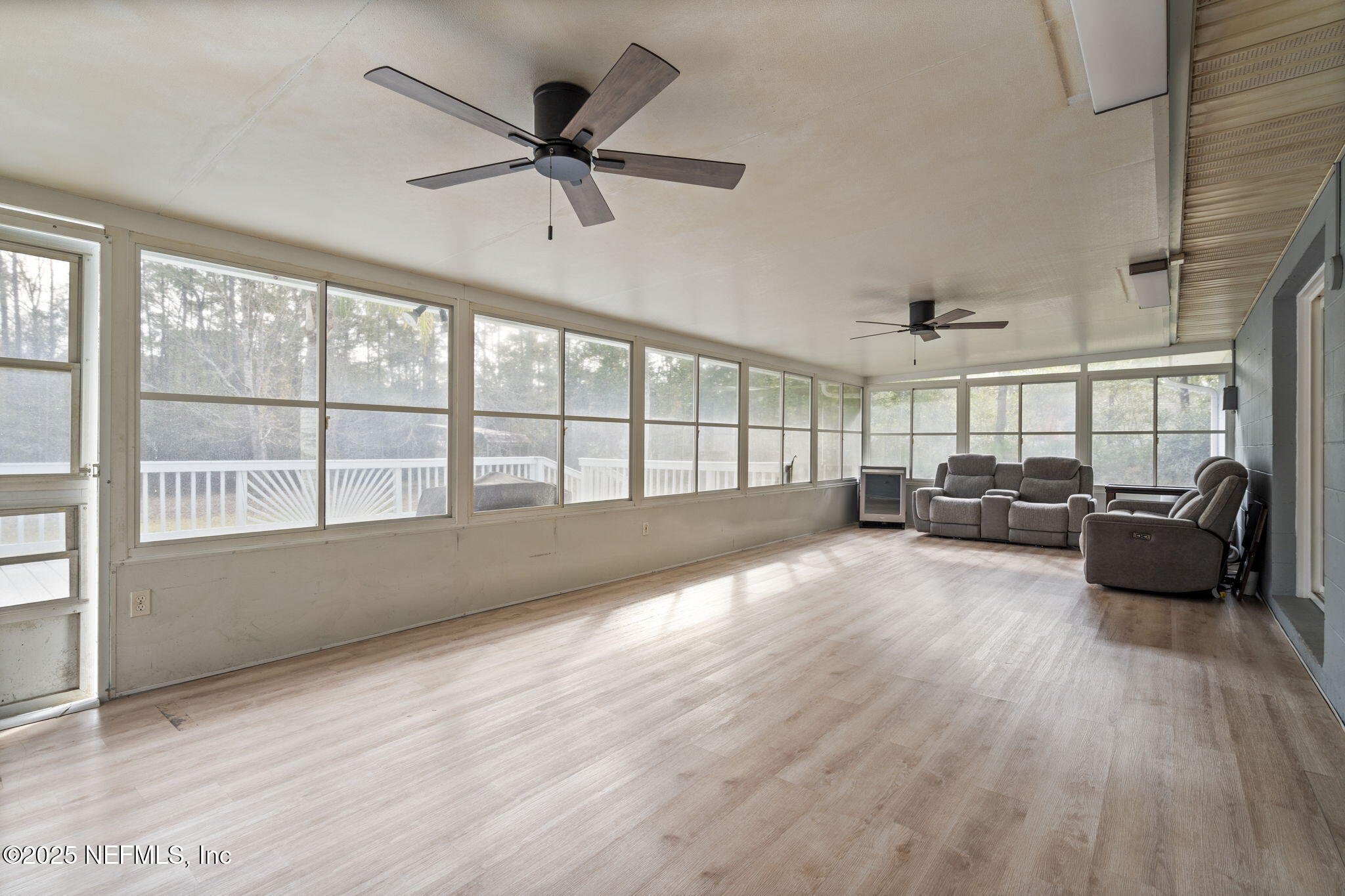 26 Bullrush Court Middleburg, FL 32068 - Photo 28 of 43 a living room with furniture and a large window with wooden floor