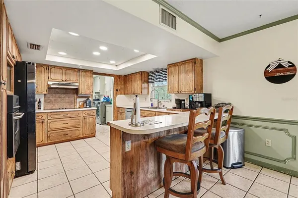 a kitchen with stainless steel appliances kitchen island granite countertop a sink and cabinets