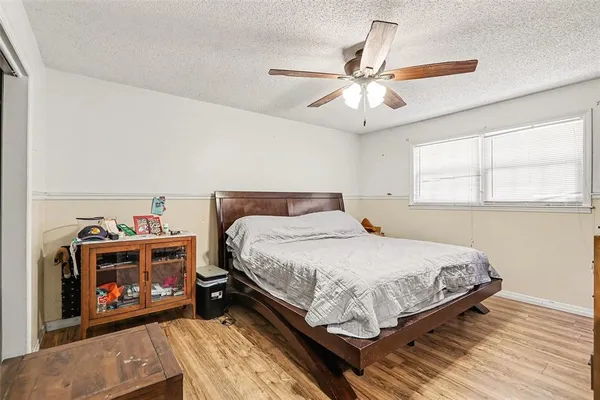 a bedroom with a bed and a ceiling fan