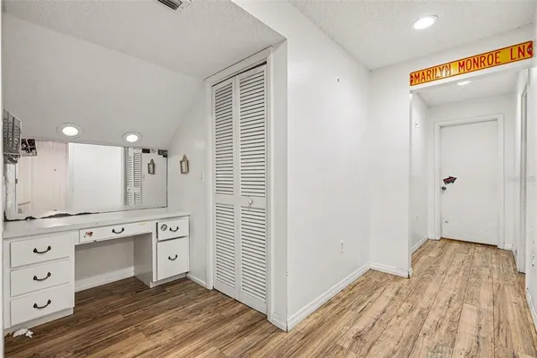 a spacious bathroom with a shower a sink and a mirror