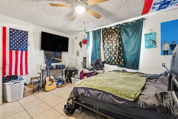 a bed sitting in a bedroom next to a window