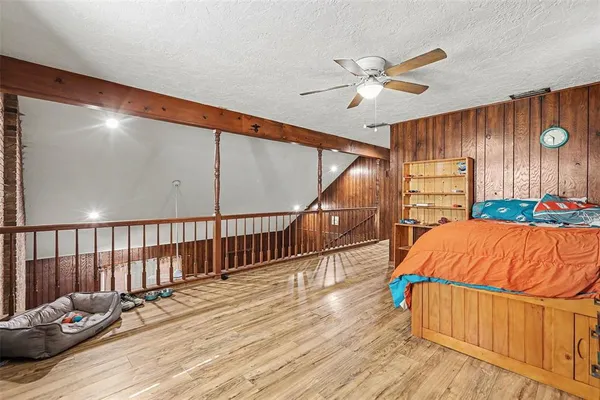 a bedroom with a bed and a chandelier