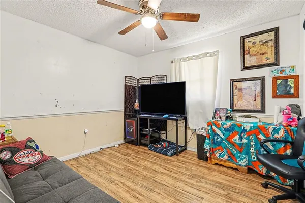a bedroom with furniture and a flat screen tv