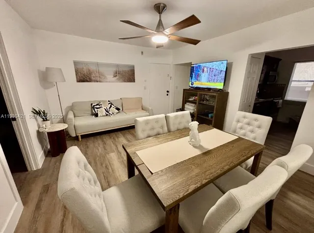 a view of a dining room with furniture and wooden floor