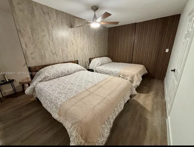 a bedroom with two beds and a chandelier
