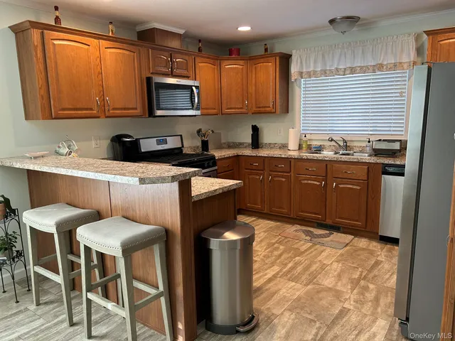 a kitchen with stainless steel appliances granite countertop a stove a sink dishwasher and a refrigerator