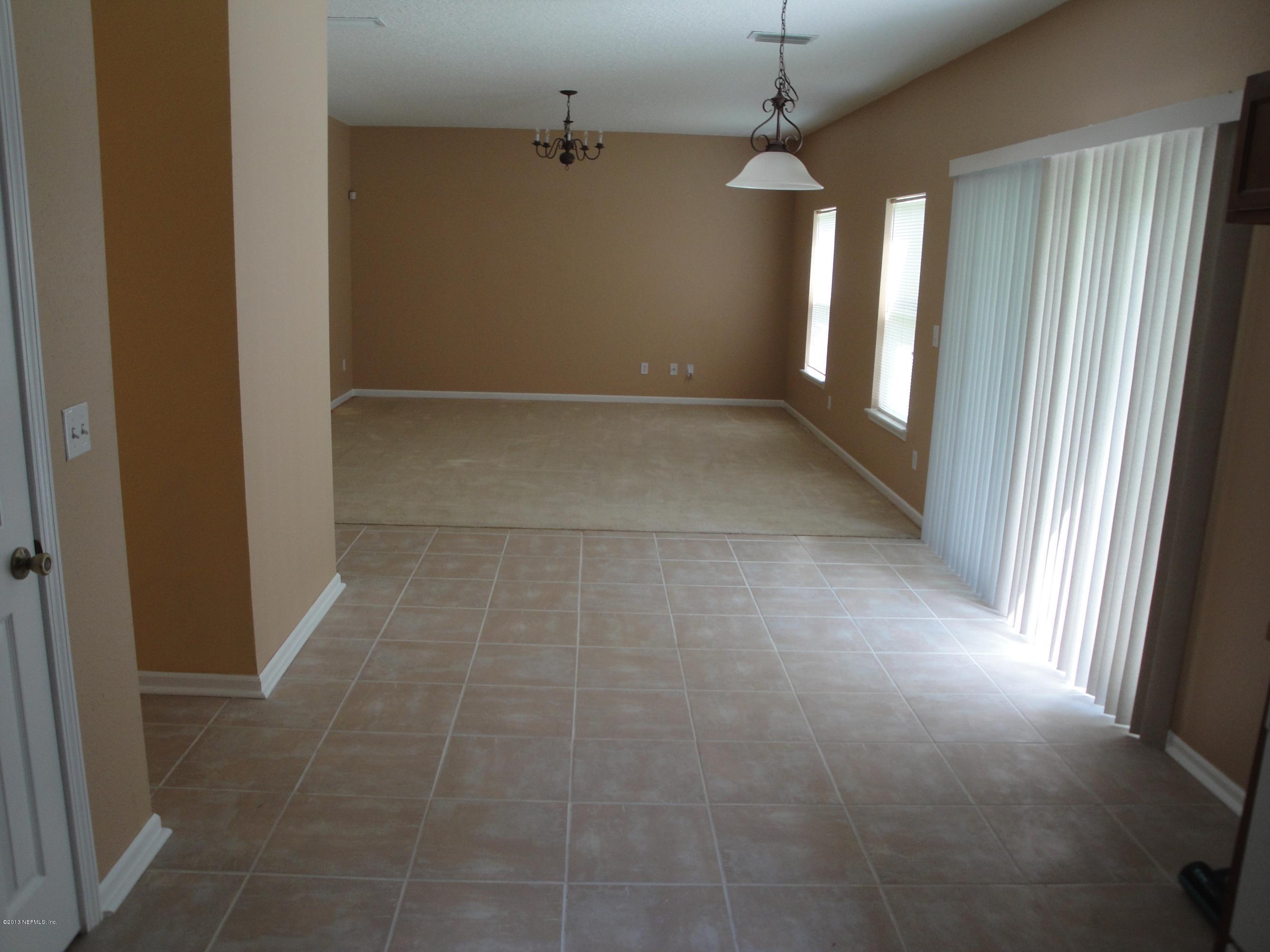7266 South Rampart Ridge Jacksonville, FL 32244 - Photo 8 of 22 a view of hallway with window and stairs
