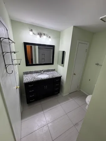 a bathroom with a double vanity sink and a mirror