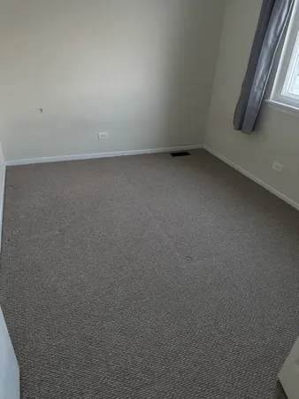 a view of an empty room and a window